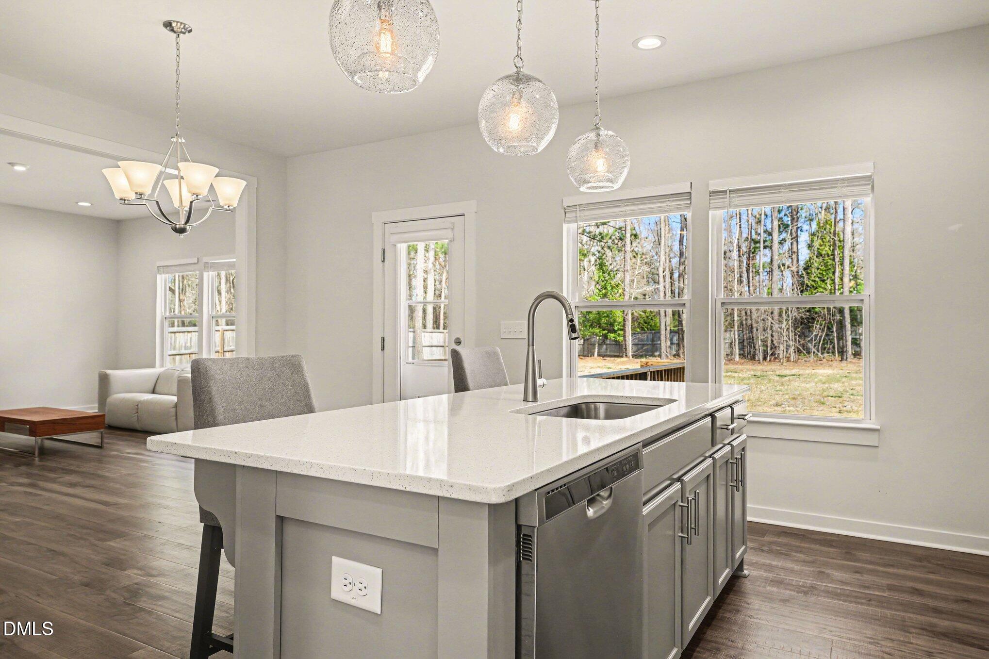 51 East Dentaires Way Willow Spring, NC 27592 - Photo 18 of 39 a kitchen with stainless steel appliances a table chairs and chandelier