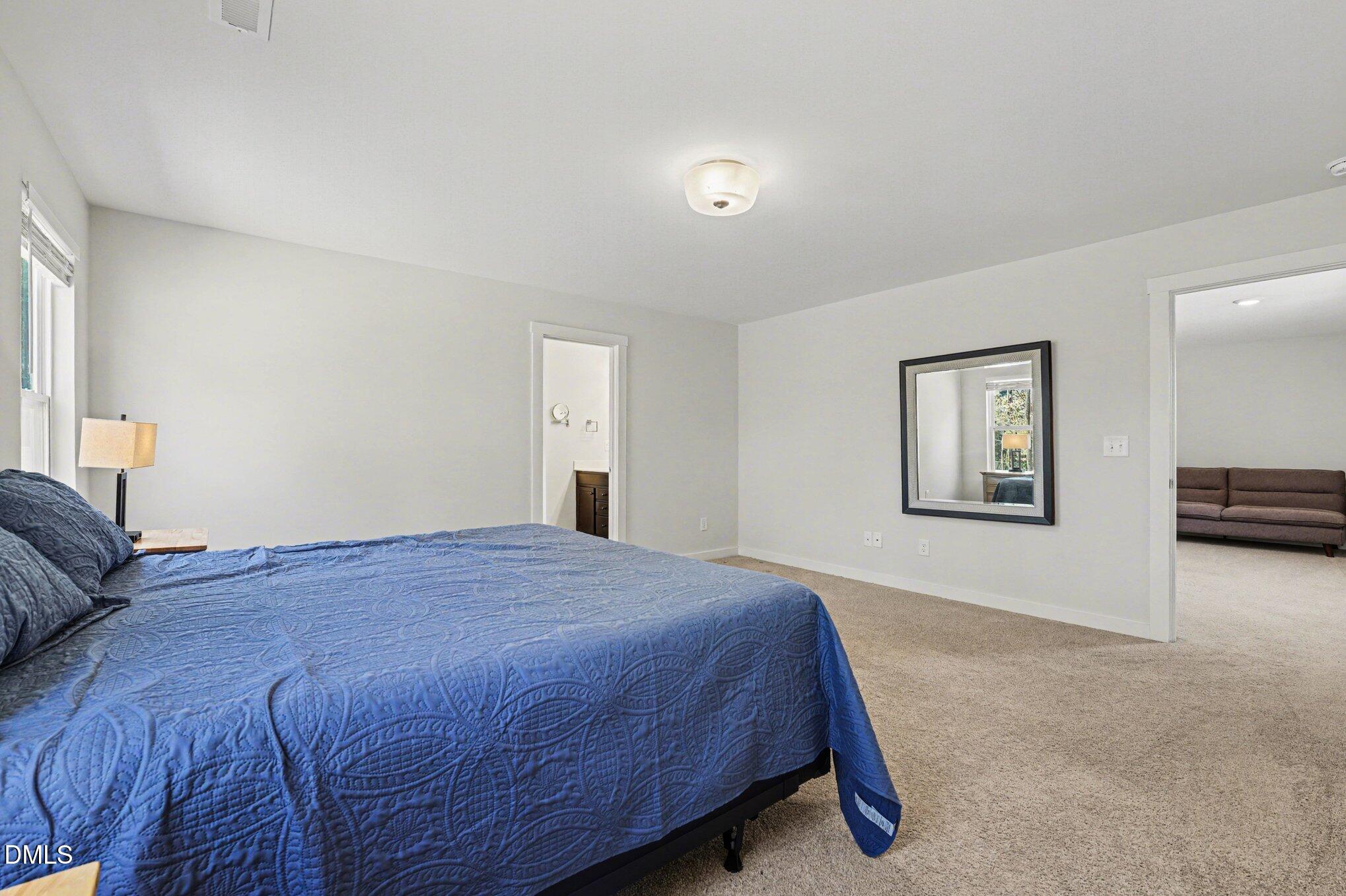 51 East Dentaires Way Willow Spring, NC 27592 - Photo 25 of 39 a spacious bedroom with a bed and a couch
