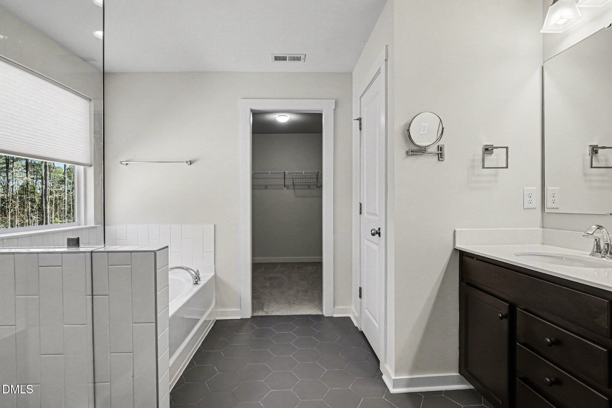 51 East Dentaires Way Willow Spring, NC 27592 - Photo 28 of 39 a bathroom with a sink and a mirror