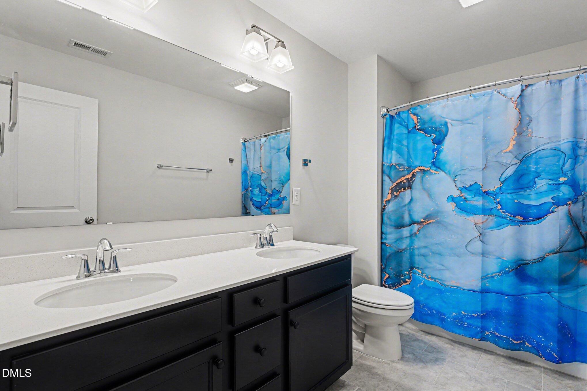 51 East Dentaires Way Willow Spring, NC 27592 - Photo 30 of 39 a bathroom with a double vanity sink mirror and toilet
