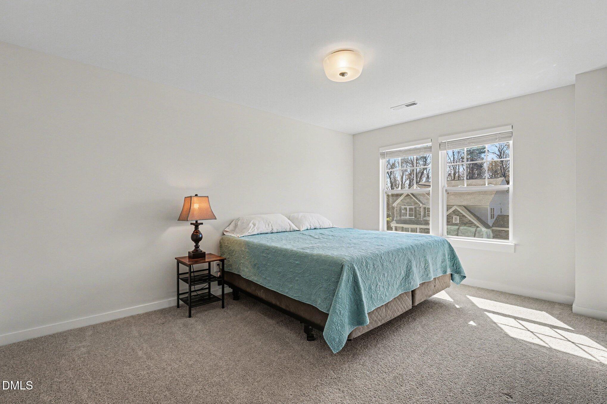 51 East Dentaires Way Willow Spring, NC 27592 - Photo 32 of 39 a bedroom with a bed and a window