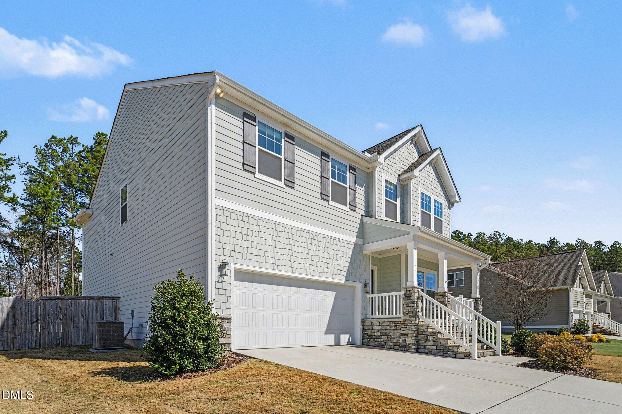 51 East Dentaires Way Willow Spring, NC 27592 - Photo 4 of 39 a front view of a house with a yard
