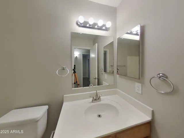 a bathroom with a sink a toilet and mirror