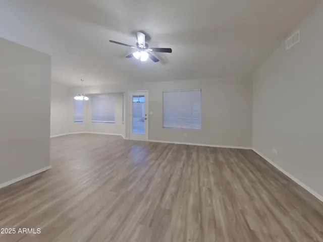 a view of a room with wooden floor