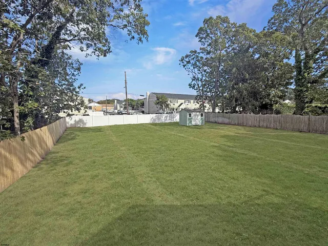 a view of pool with outdoor seating and yard