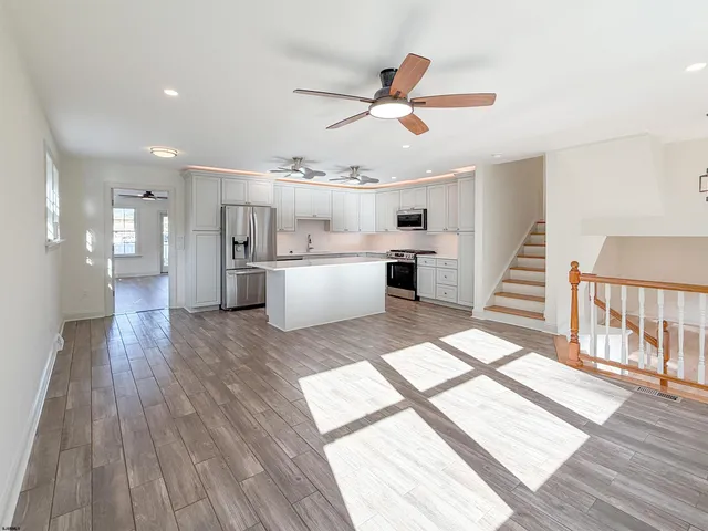 a view of a living room and wooden floor