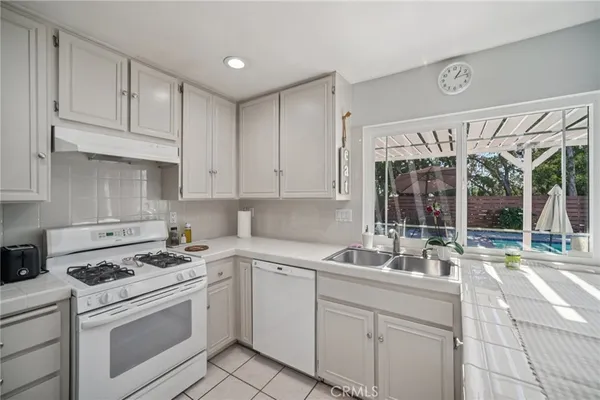 a kitchen with appliances cabinets and furniture