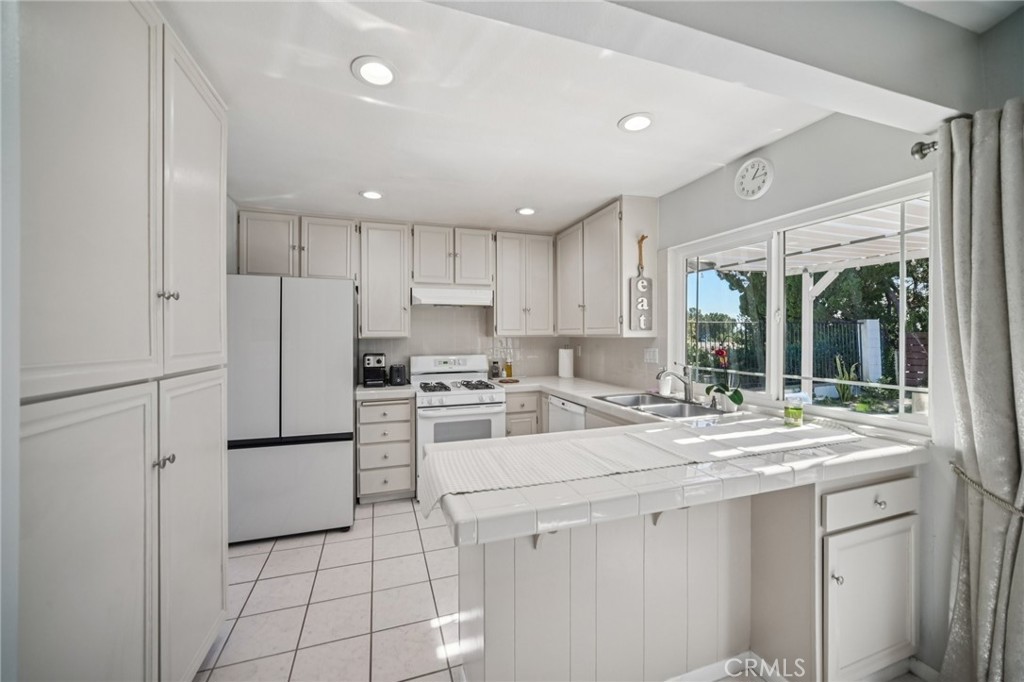 11461 Amigo Avenue Porter Ranch, CA 91326 - Photo 14 of 52 a kitchen with appliances cabinets and furniture