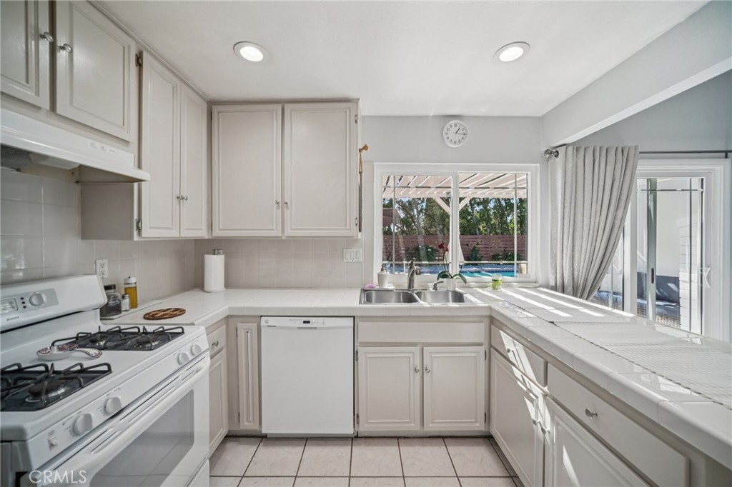 11461 Amigo Avenue Porter Ranch, CA 91326 - Photo 15 of 52 a kitchen with a sink stove top oven and cabinets