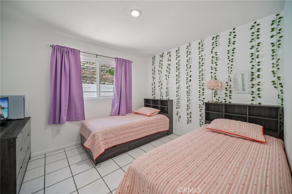 11461 Amigo Avenue Porter Ranch, CA 91326 - Photo 18 of 52 a bedroom with double bed and a window