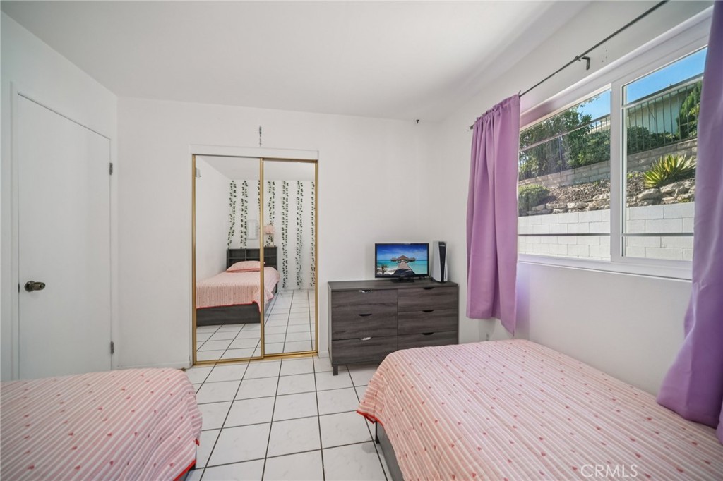 11461 Amigo Avenue Porter Ranch, CA 91326 - Photo 19 of 52 a bedroom with a bed and a window