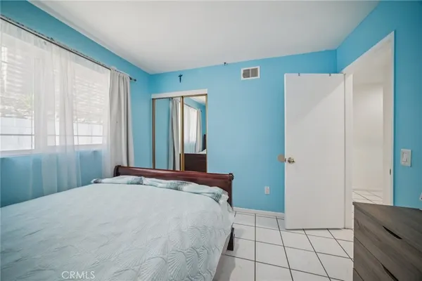 a bedroom with a bed and glass window