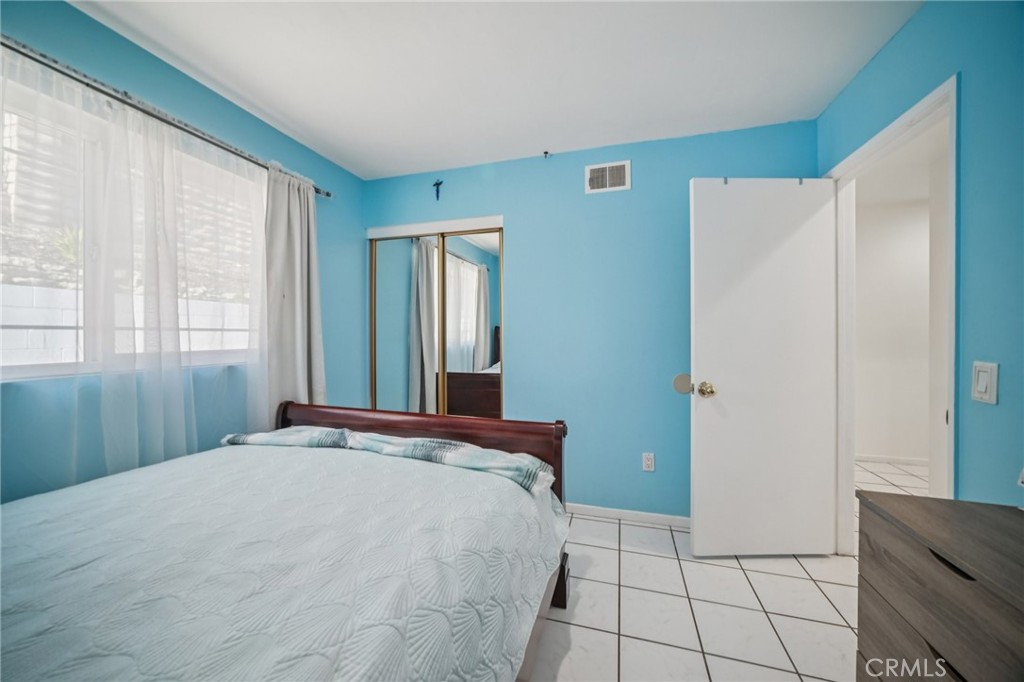 11461 Amigo Avenue Porter Ranch, CA 91326 - Photo 21 of 52 a bedroom with a bed and a window