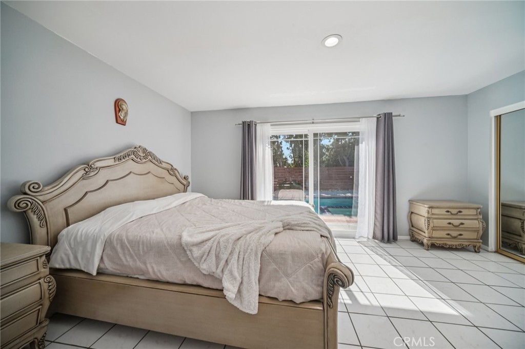 11461 Amigo Avenue Porter Ranch, CA 91326 - Photo 22 of 52 a bedroom with a bed and a window