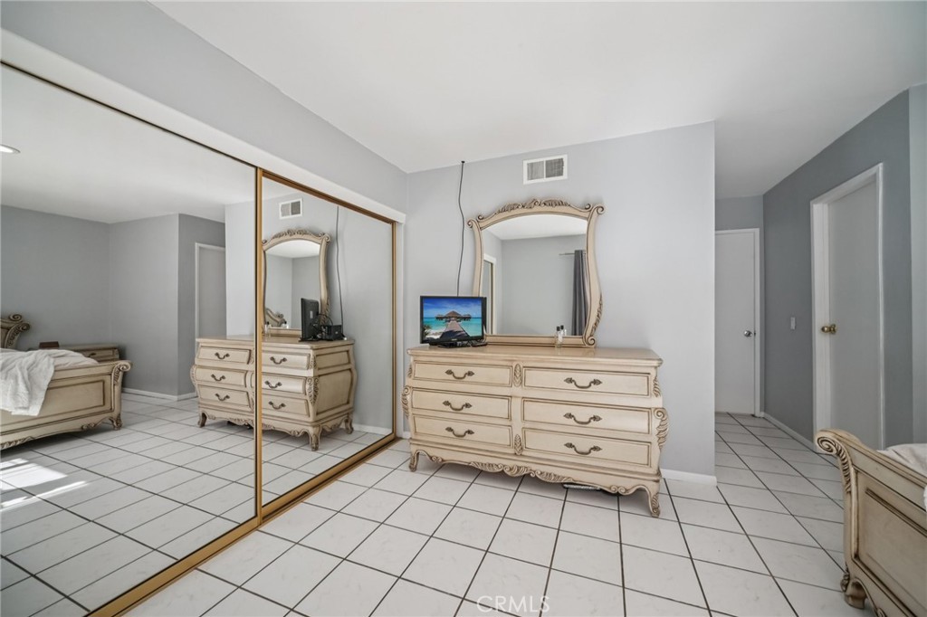 11461 Amigo Avenue Porter Ranch, CA 91326 - Photo 23 of 52 a room with a baby bed and a mirror