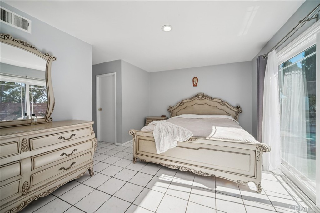 11461 Amigo Avenue Porter Ranch, CA 91326 - Photo 24 of 52 a bedroom with a bed and a dresser