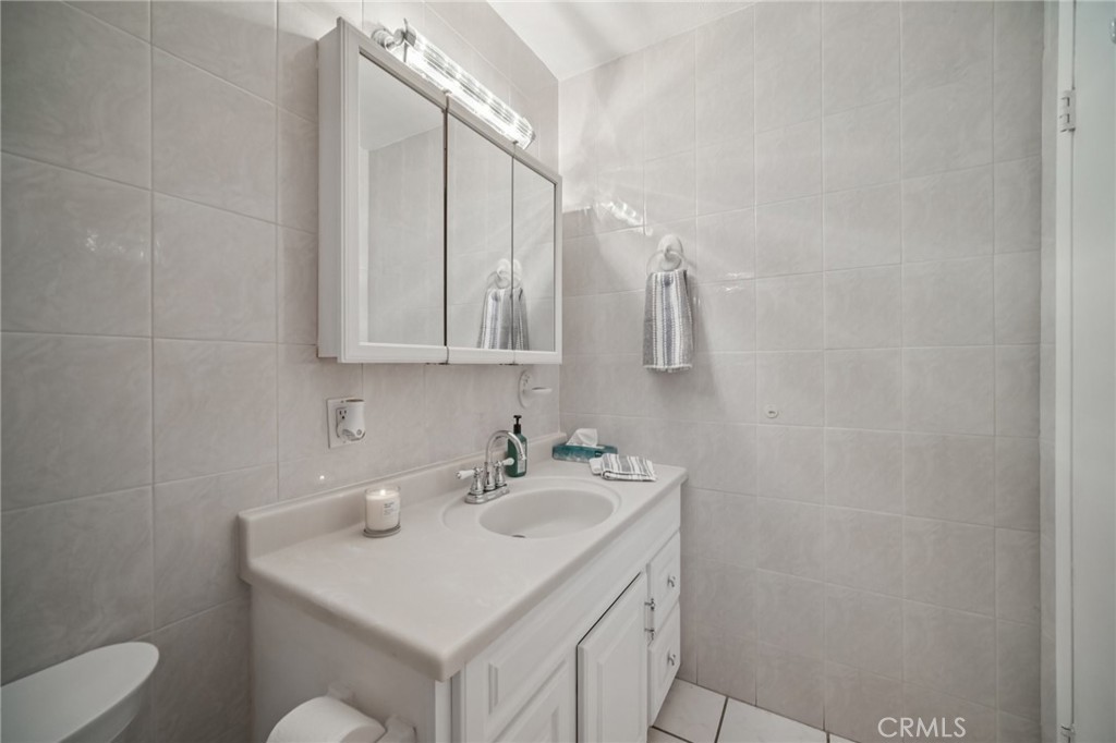 11461 Amigo Avenue Porter Ranch, CA 91326 - Photo 26 of 52 a bathroom with a sink toilet and mirror