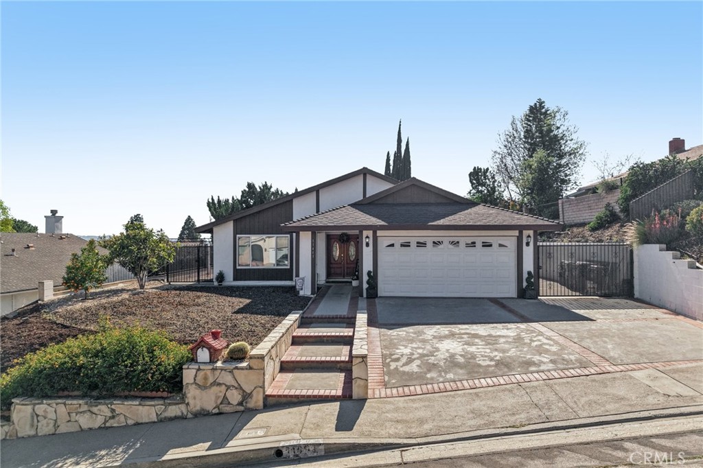 11461 Amigo Avenue Porter Ranch, CA 91326 - Photo 39 of 52 a front view of a house with a garden