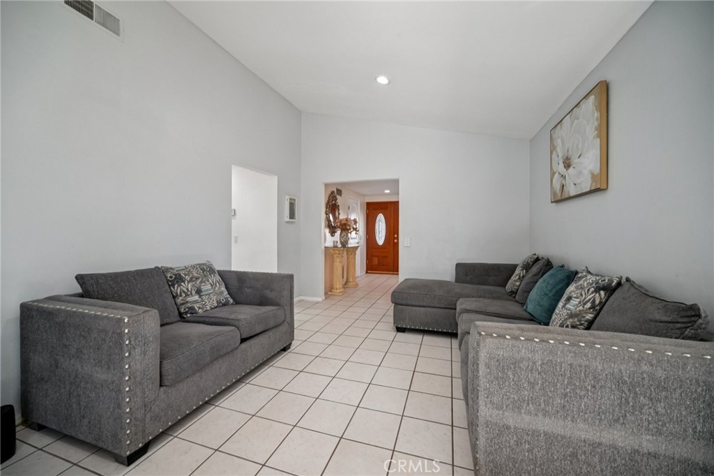 11461 Amigo Avenue Porter Ranch, CA 91326 - Photo 9 of 52 a living room with furniture and a couch