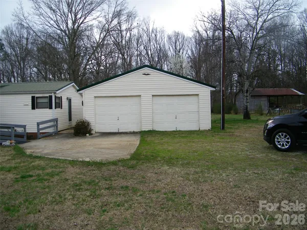 a view of a house with a yard and garage