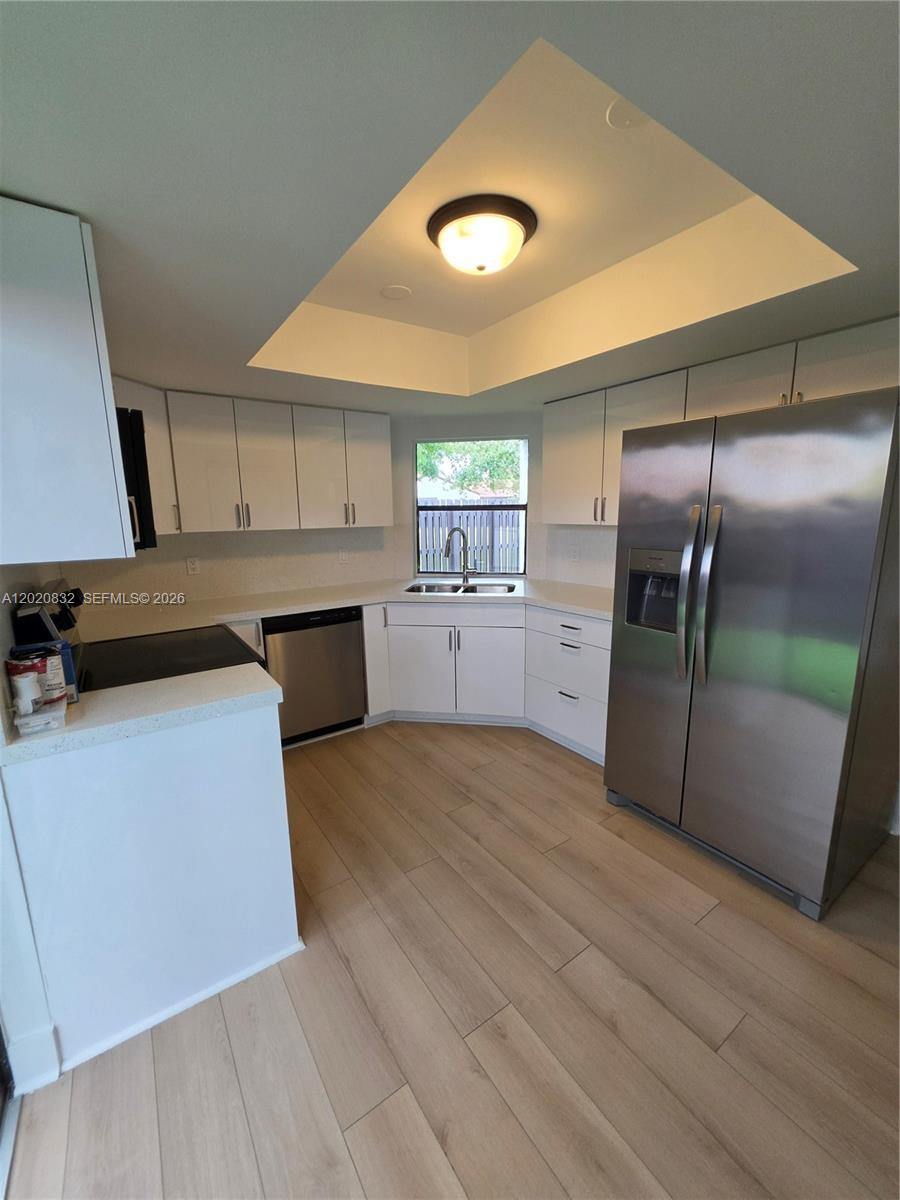 15240 Southwest 45th Terrace, Unit 54F Miami, FL 33185 - Photo 21 of 48 a kitchen with stainless steel appliances granite countertop a refrigerator a sink and a stove