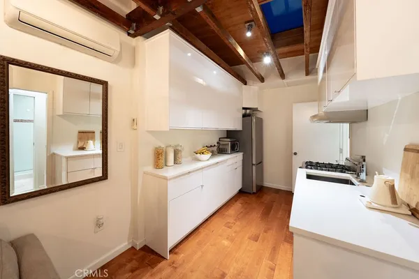 a kitchen with stainless steel appliances granite countertop a sink a stove and a refrigerator