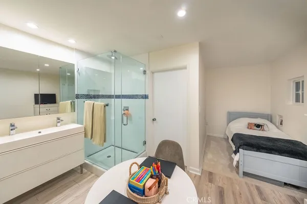 a bathroom with a shower a sink and a mirror