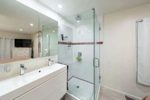 a spacious bathroom with a toilet a sink and shower