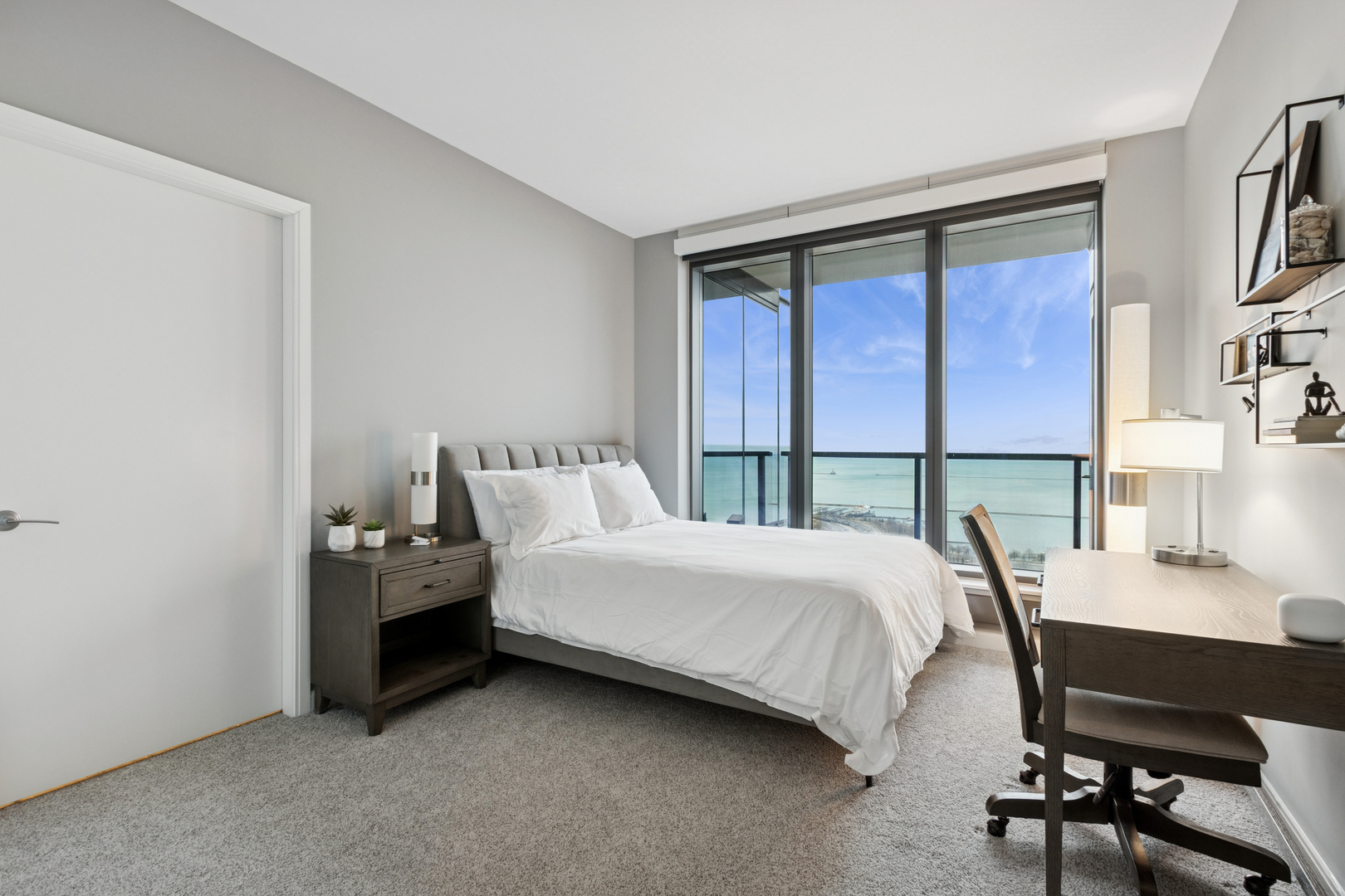 60 East Monroe Street, Unit 3402 Chicago, IL 60603 - Photo 18 of 31 a bedroom with a bed and a table in it