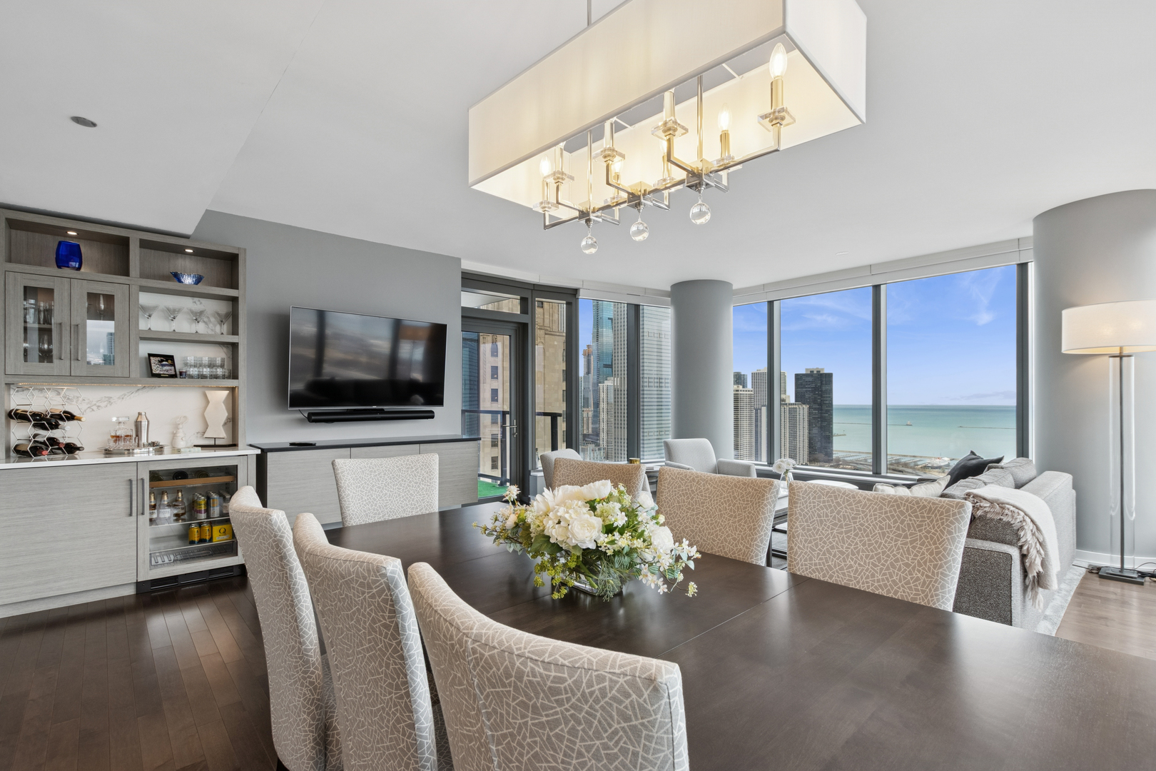 60 East Monroe Street, Unit 3402 Chicago, IL 60603 - Photo 6 of 31 a living room with furniture and a flat screen tv