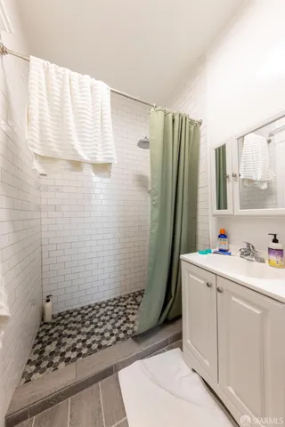 a bathroom with a sink toilet and shower