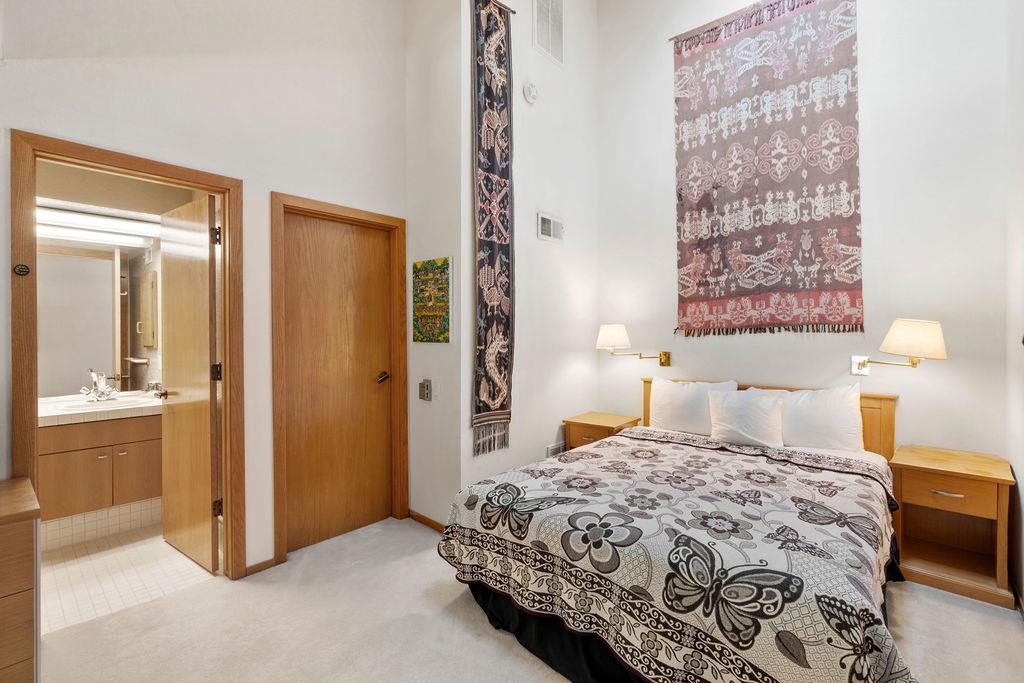 201 Shirley Cyn Road, Unit 309 Olympic Valley, CA 96146 - Photo 9 of 28 a bedroom with a bed and a lamp with table