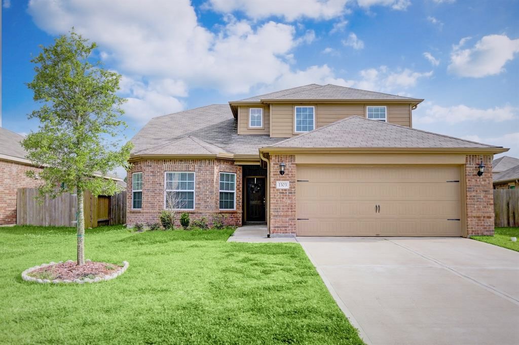 1303 Emerald Stone Drive Rosharon, TX 77583 - Photo 22 of 25 Charming exterior showcasing established trees and thoughtfully designed flowerbeds for a warm and welcoming first impression.