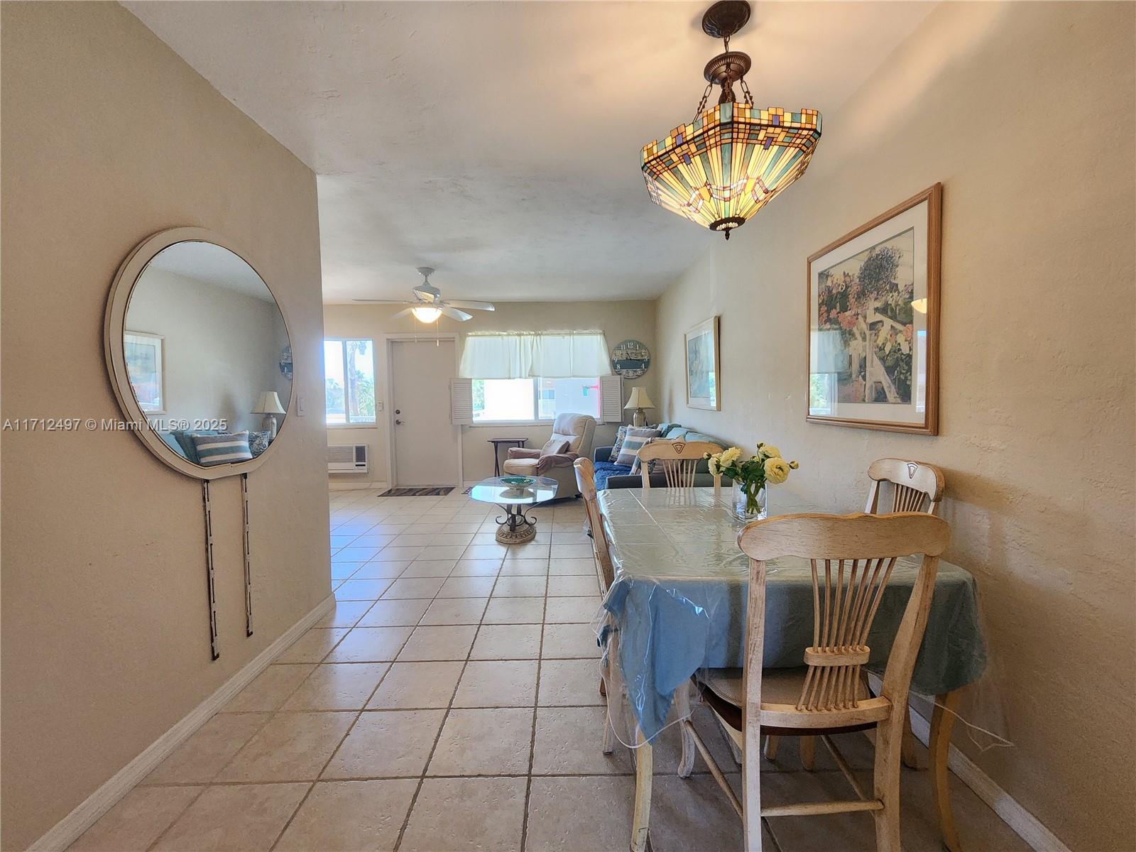 1504 South Surf Road, Unit 57 Hollywood, FL 33019 - Photo 11 of 27 a view of a dining room with furniture and a chandelier