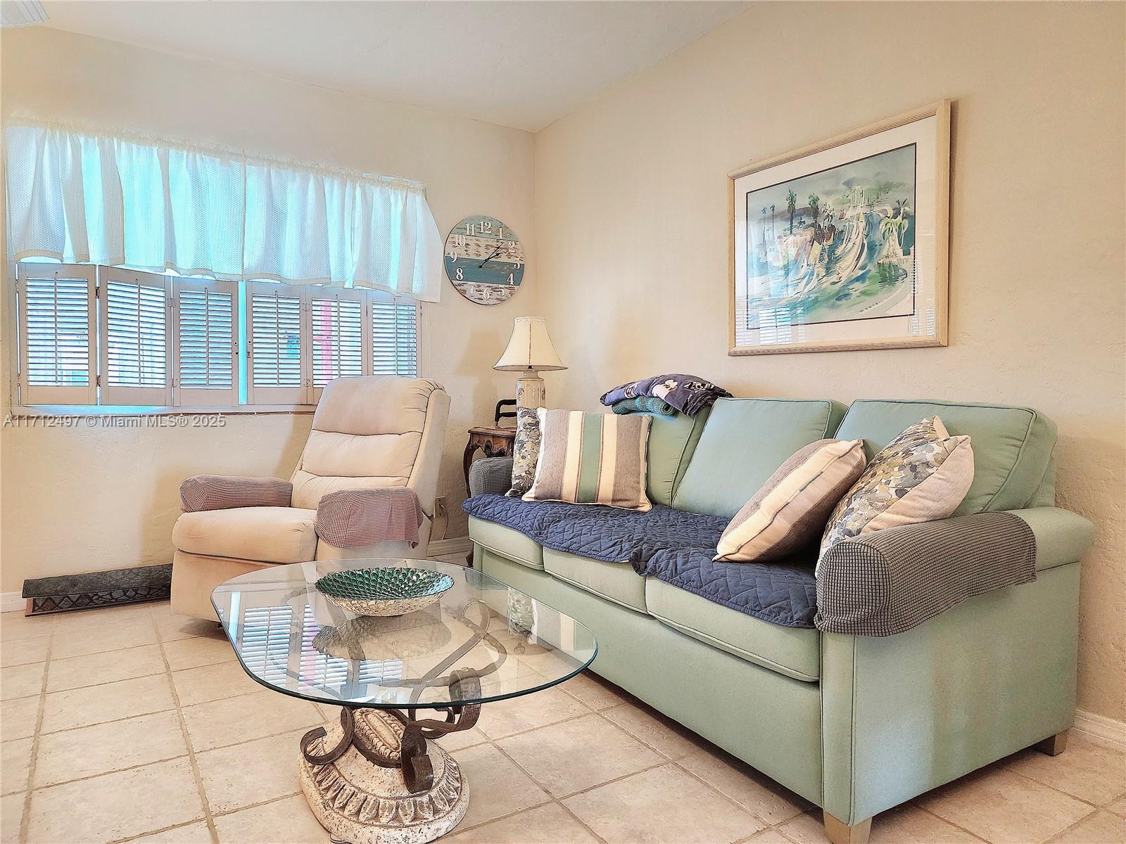 1504 South Surf Road, Unit 57 Hollywood, FL 33019 - Photo 14 of 27 a living room with furniture and a large window