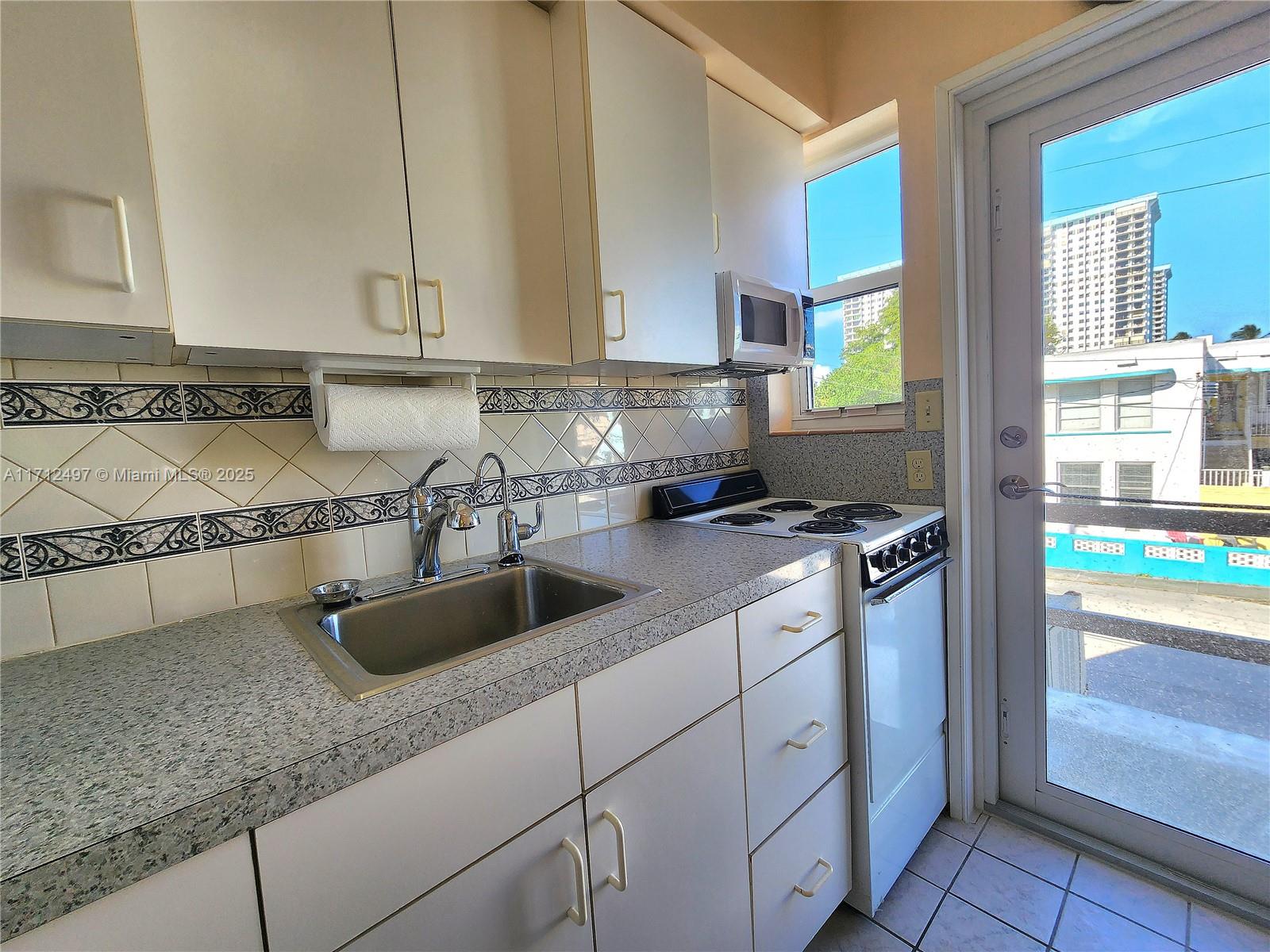 1504 South Surf Road, Unit 57 Hollywood, FL 33019 - Photo 16 of 27 a kitchen with granite countertop a sink and a stove