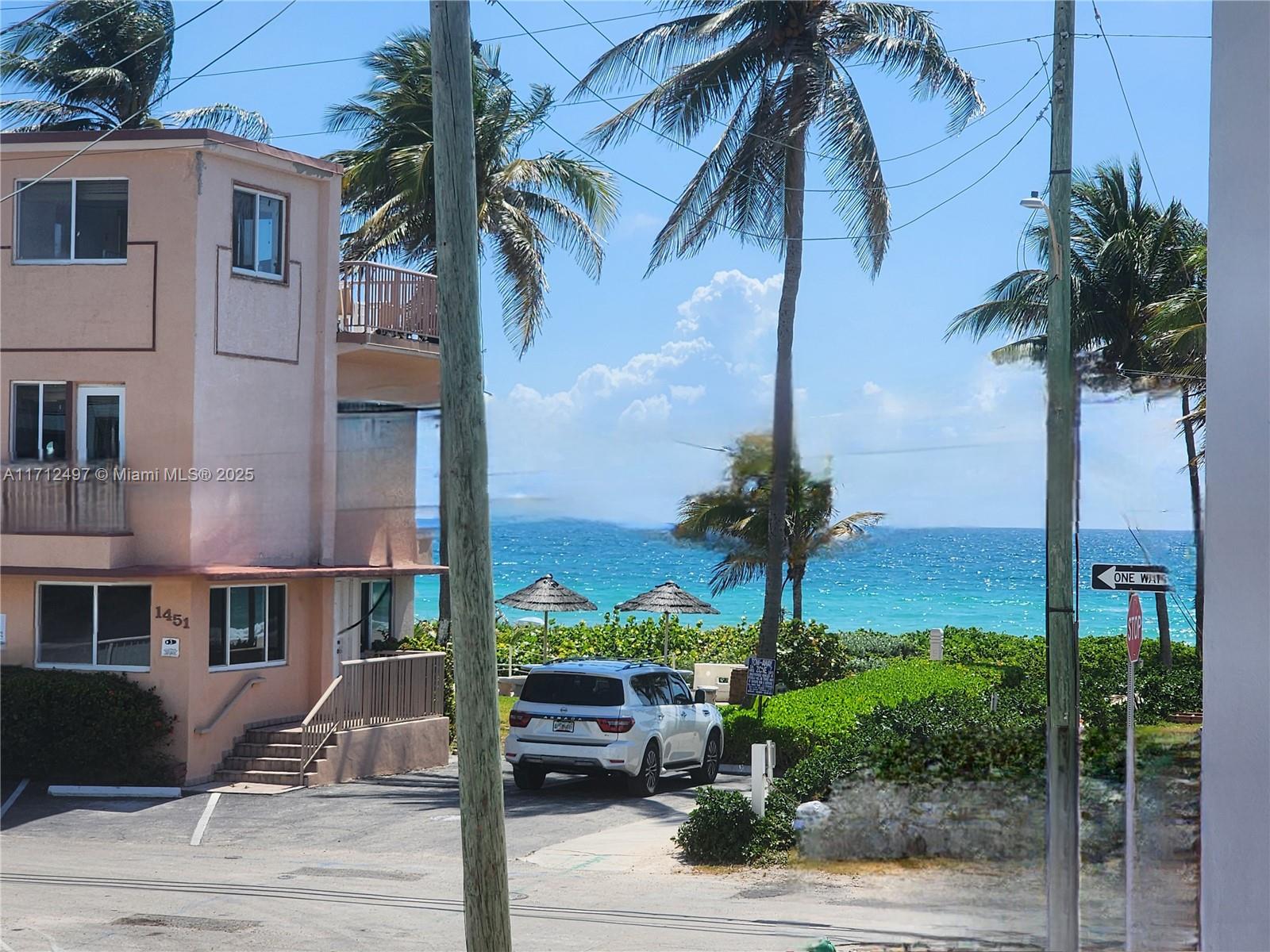 1504 South Surf Road, Unit 57 Hollywood, FL 33019 - Photo 18 of 27 a palm tree sitting in front of a house
