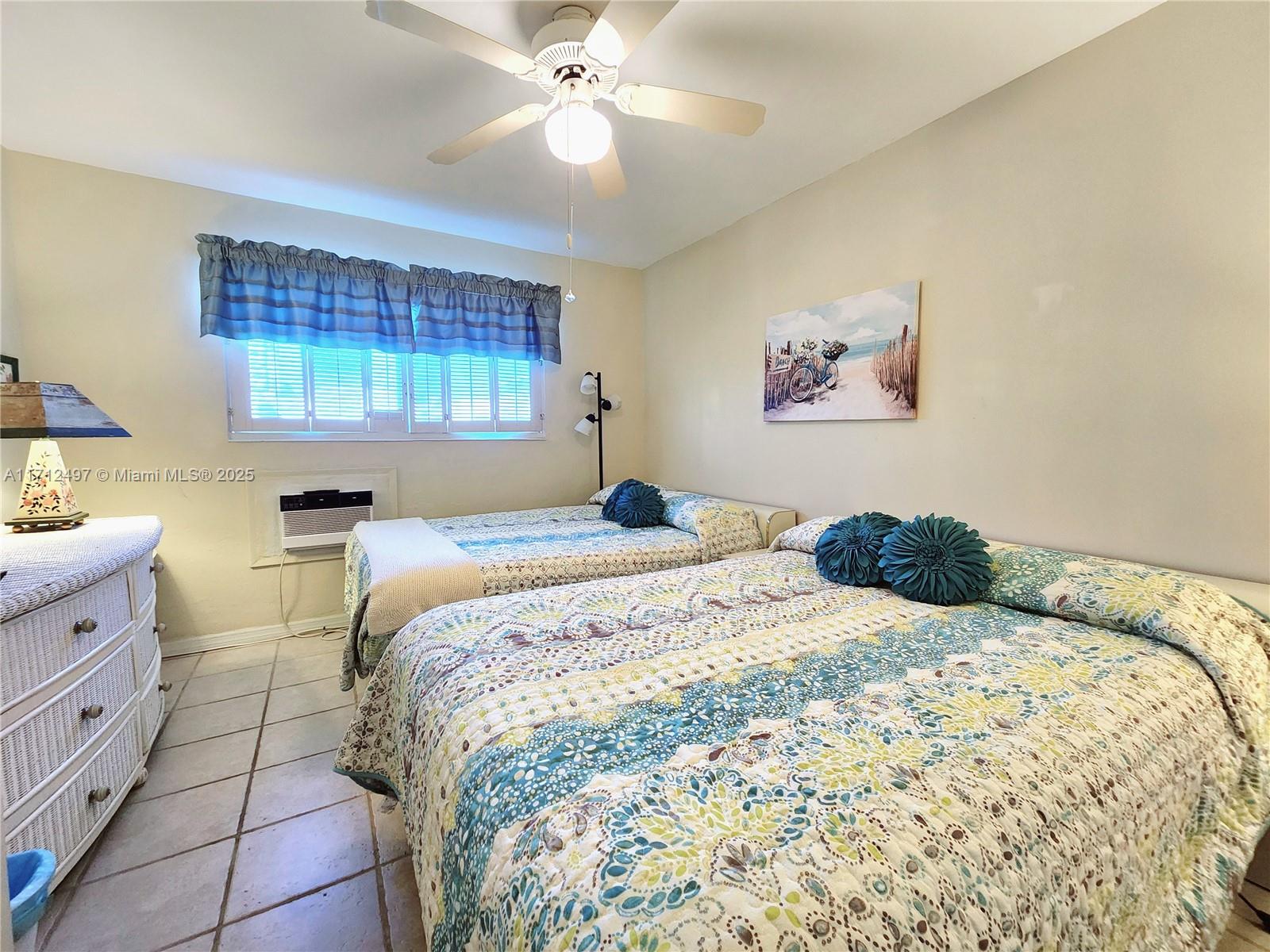 1504 South Surf Road, Unit 57 Hollywood, FL 33019 - Photo 20 of 27 a bedroom with a bed and a chandelier