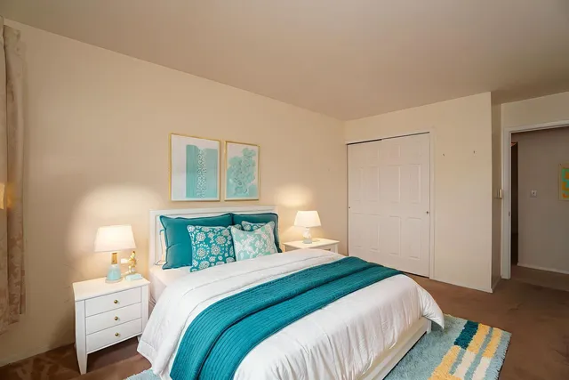 a bedroom with a bed and a window