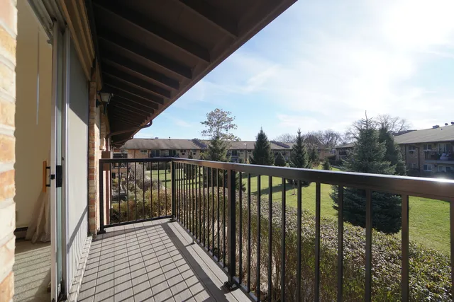 a view of a balcony with wooden floor