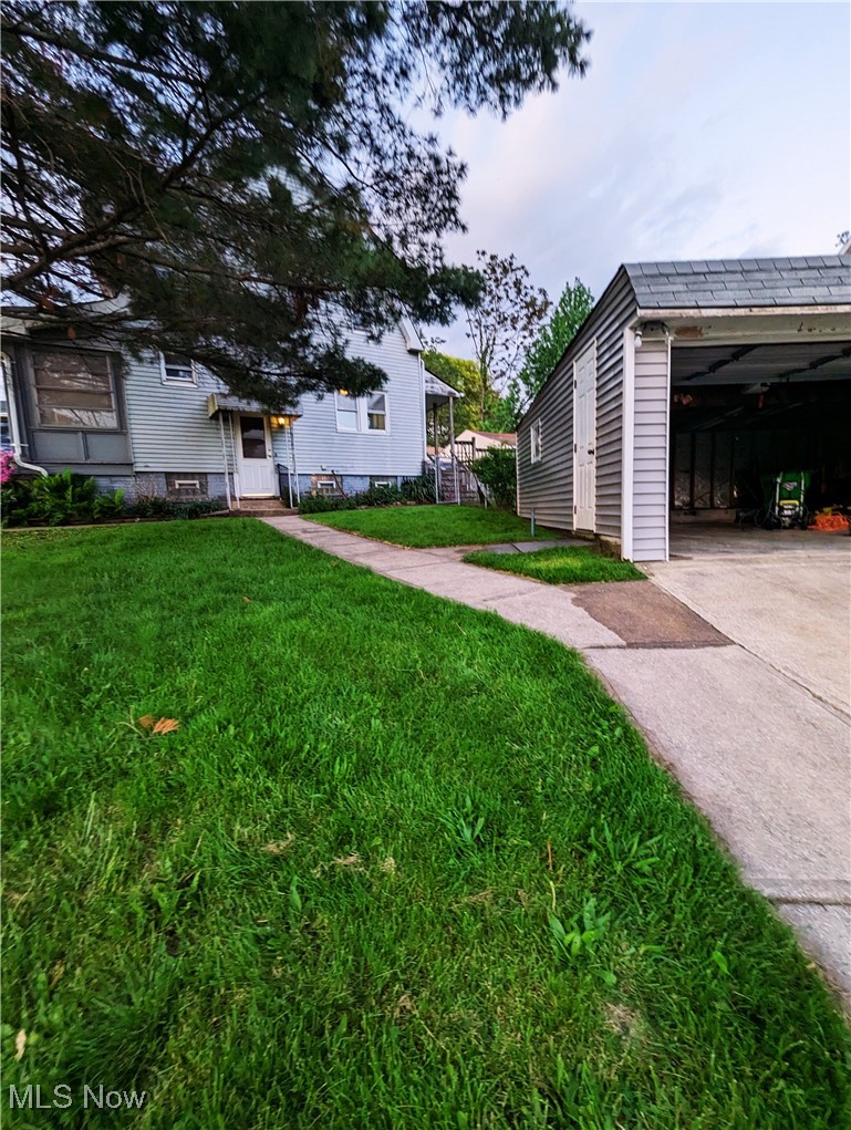 4745 Blythin Road Cleveland, OH 44125 - Photo 2 of 30 View of green lawn with concrete driveway