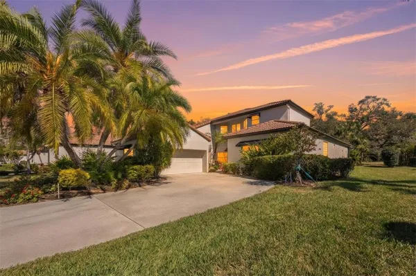 a view of a house with a yard and pathway