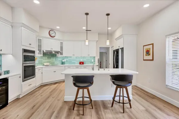 a kitchen with stainless steel appliances kitchen island granite countertop a sink and cabinets