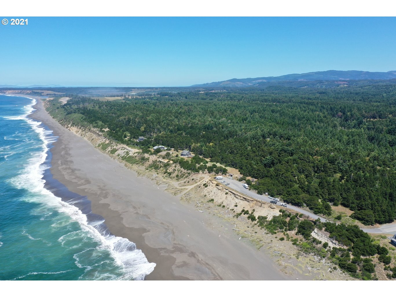 0 Gull Rd Port, Unit 1900 Port Orford, OR 97465 - Photo 7 of 18 a view of a beach with a mountain