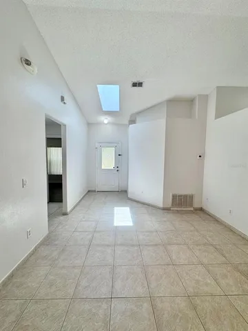 a view of an empty room and a window
