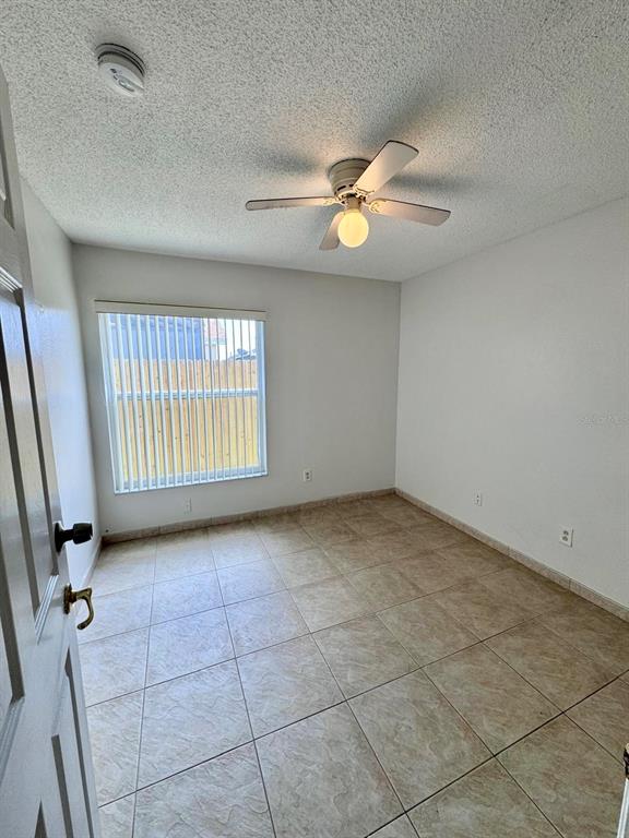 147 South Roma Way Kissimmee, FL 34746 - Photo 9 of 11 wooden floor in an empty room with a window
