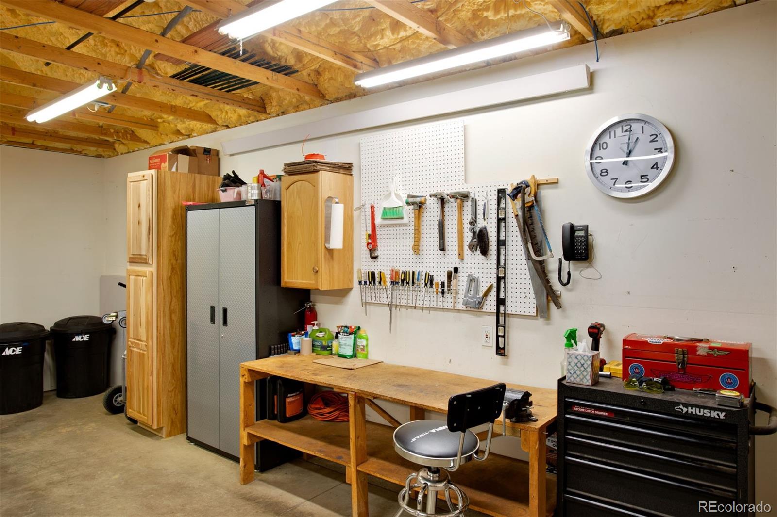427 Wilderness Ridge Way Bellvue, CO 80512 - Photo 12 of 50 a living room with furniture and a clock