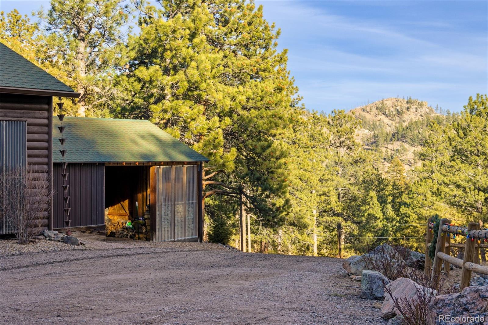427 Wilderness Ridge Way Bellvue, CO 80512 - Photo 13 of 50 a view of a house with backyard and trees