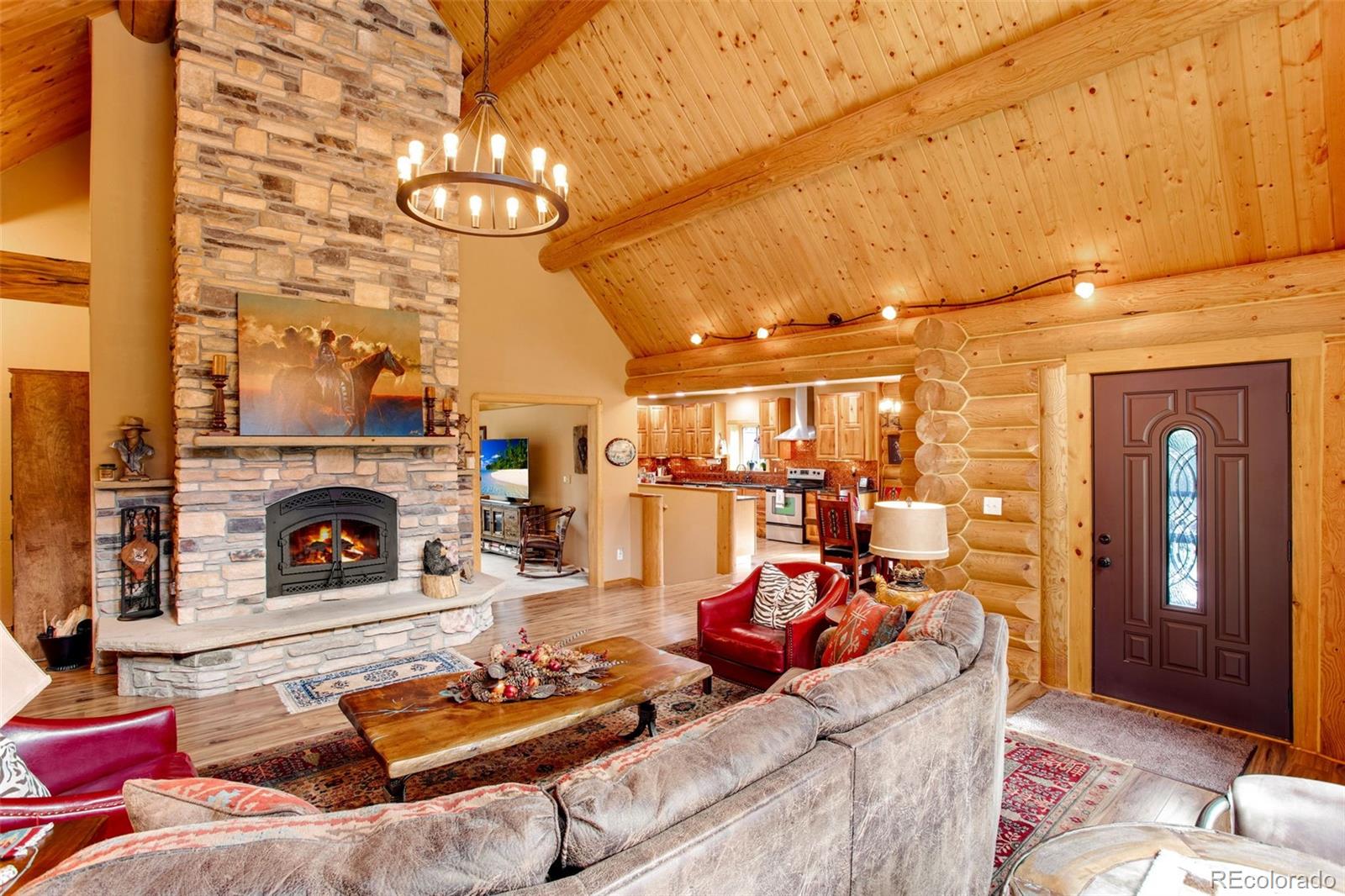 427 Wilderness Ridge Way Bellvue, CO 80512 - Photo 15 of 50 a living room with furniture and a fireplace