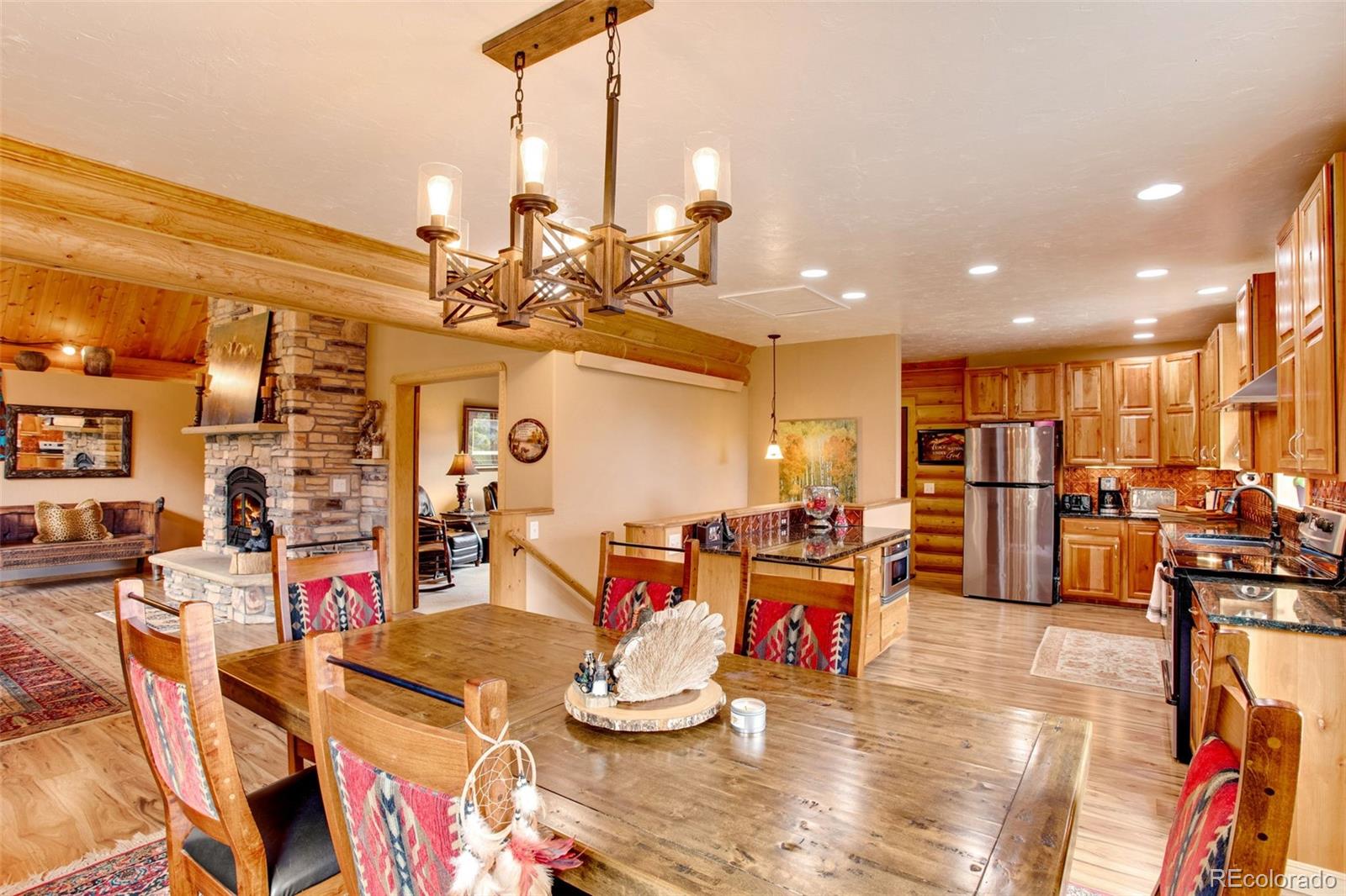 427 Wilderness Ridge Way Bellvue, CO 80512 - Photo 19 of 50 a living room with lots of chairs and a table
